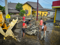 Residents in Lemery, Batangas, were seen cleaning up mud and debris on October 25, 2024, after Tropical Storm Kristine caused severe floodin...