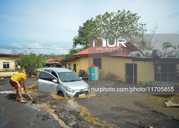 Residents in Lemery, Batangas, were seen cleaning up mud and debris on October 25, 2024, after Tropical Storm Kristine caused severe floodin...