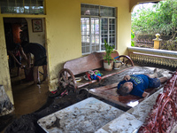 Residents in Lemery, Batangas, were seen cleaning up mud and debris on October 25, 2024, after Tropical Storm Kristine caused severe floodin...