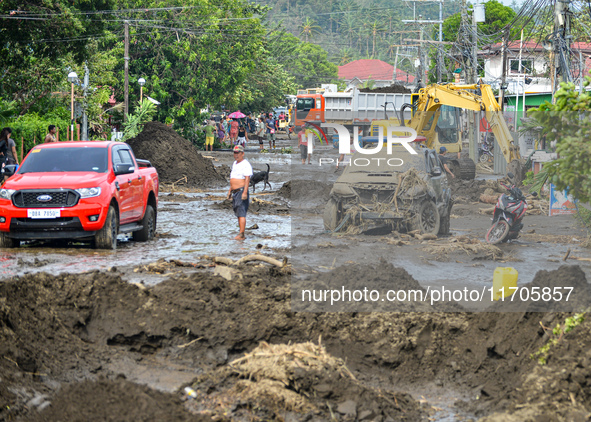 Residents in Lemery, Batangas, were seen cleaning up mud and debris on October 25, 2024, after Tropical Storm Kristine caused severe floodin...