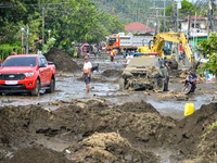 Residents in Lemery, Batangas, were seen cleaning up mud and debris on October 25, 2024, after Tropical Storm Kristine caused severe floodin...