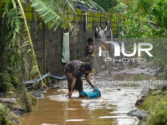 Residents in Lemery, Batangas, were seen cleaning up mud and debris on October 25, 2024, after Tropical Storm Kristine caused severe floodin...