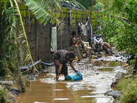 Residents in Lemery, Batangas, were seen cleaning up mud and debris on October 25, 2024, after Tropical Storm Kristine caused severe floodin...