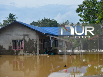 Residents in Lemery, Batangas, were seen cleaning up mud and debris on October 25, 2024, after Tropical Storm Kristine caused severe floodin...