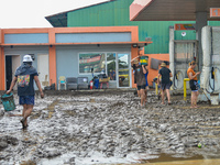 Residents in Lemery, Batangas, were seen cleaning up mud and debris on October 25, 2024, after Tropical Storm Kristine caused severe floodin...