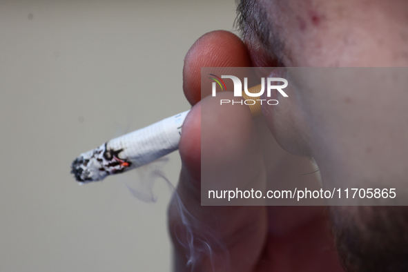 A person smokes a cigarette in Krakow, Poland on October 25, 2024. 