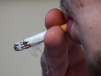 A person smokes a cigarette in Krakow, Poland on October 25, 2024. (