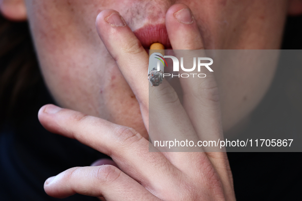 A person smokes a cigarette in Krakow, Poland on October 25, 2024. 