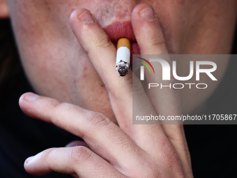 A person smokes a cigarette in Krakow, Poland on October 25, 2024. (