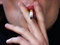 A person smokes a cigarette in Krakow, Poland on October 25, 2024. (