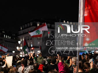 A protester holds a sign reading ''Israel extermine in Gaza'' during a demonstration in support of Palestinian and Lebanese people as intens...