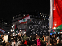 A protester holds a sign reading ''Israel extermine in Gaza'' during a demonstration in support of Palestinian and Lebanese people as intens...