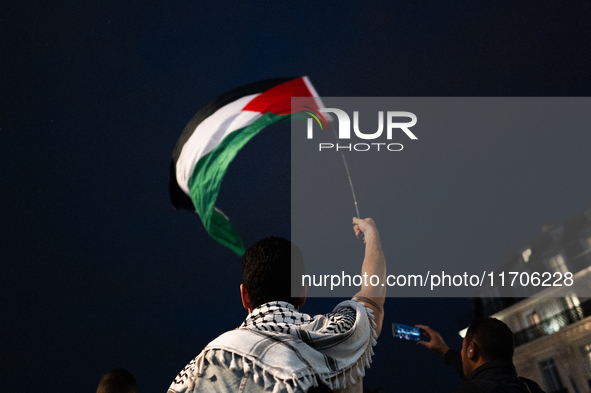 Protesters with flags attend a demonstration in support of Palestinian and Lebanese people as intense Israeli attacks occur in Gaza and Leba...