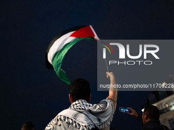 Protesters with flags attend a demonstration in support of Palestinian and Lebanese people as intense Israeli attacks occur in Gaza and Leba...