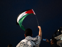 Protesters with flags attend a demonstration in support of Palestinian and Lebanese people as intense Israeli attacks occur in Gaza and Leba...