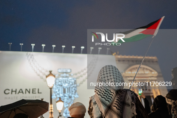 Protesters with flags attend a demonstration in support of Palestinian and Lebanese people as intense Israeli attacks occur in Gaza and Leba...