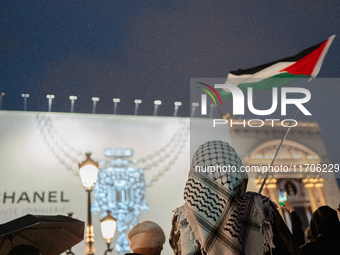 Protesters with flags attend a demonstration in support of Palestinian and Lebanese people as intense Israeli attacks occur in Gaza and Leba...