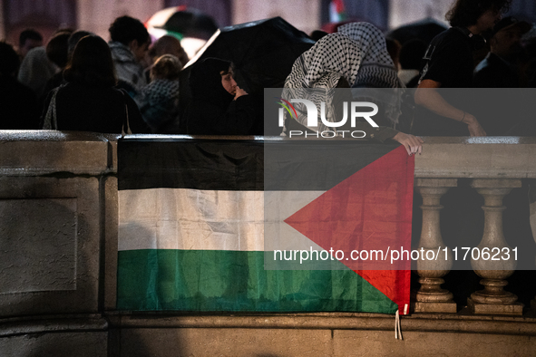 Protesters with flags attend a demonstration in support of Palestinian and Lebanese people as intense Israeli attacks occur in Gaza and Leba...