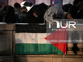 Protesters with flags attend a demonstration in support of Palestinian and Lebanese people as intense Israeli attacks occur in Gaza and Leba...