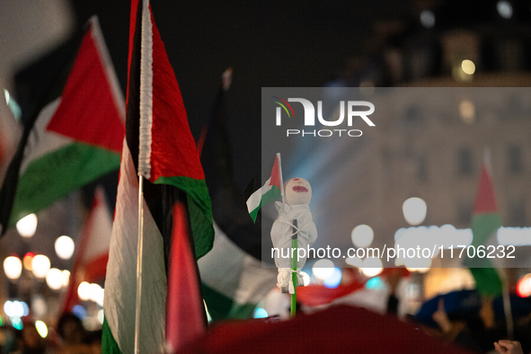 Protesters with flags attend a demonstration in support of Palestinian and Lebanese people as intense Israeli attacks occur in Gaza and Leba...