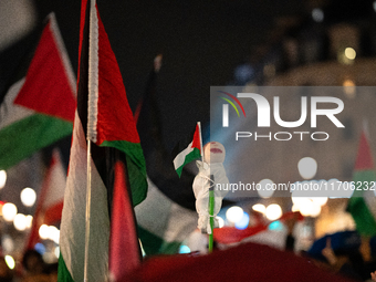 Protesters with flags attend a demonstration in support of Palestinian and Lebanese people as intense Israeli attacks occur in Gaza and Leba...