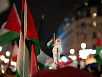 Protesters with flags attend a demonstration in support of Palestinian and Lebanese people as intense Israeli attacks occur in Gaza and Leba...