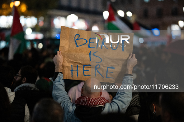 A protester holds a sign reading ''Beirut is here'' during a demonstration in support of Palestinian and Lebanese people as intense Israeli...