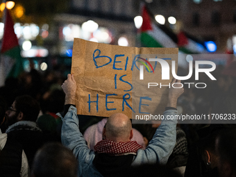 A protester holds a sign reading ''Beirut is here'' during a demonstration in support of Palestinian and Lebanese people as intense Israeli...