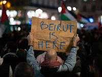 A protester holds a sign reading ''Beirut is here'' during a demonstration in support of Palestinian and Lebanese people as intense Israeli...