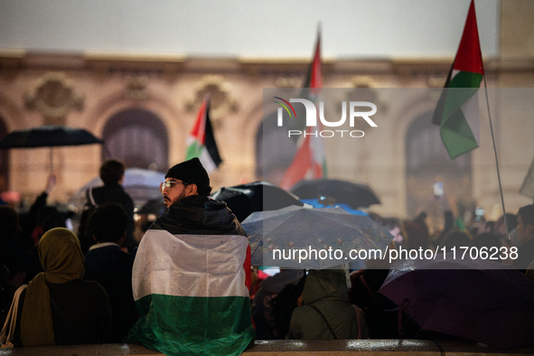 Protesters with flags attend a demonstration in support of Palestinian and Lebanese people as intense Israeli attacks occur in Gaza and Leba...