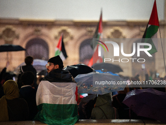 Protesters with flags attend a demonstration in support of Palestinian and Lebanese people as intense Israeli attacks occur in Gaza and Leba...