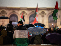 Protesters with flags attend a demonstration in support of Palestinian and Lebanese people as intense Israeli attacks occur in Gaza and Leba...