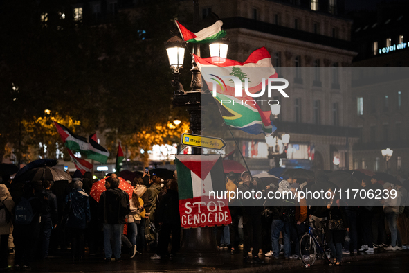 Protesters with flags attend a demonstration in support of Palestinian and Lebanese people as intense Israeli attacks occur in Gaza and Leba...