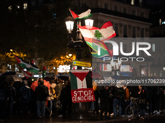 Protesters with flags attend a demonstration in support of Palestinian and Lebanese people as intense Israeli attacks occur in Gaza and Leba...