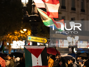 Protesters with flags attend a demonstration in support of Palestinian and Lebanese people as intense Israeli attacks occur in Gaza and Leba...