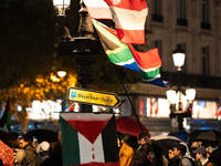 Protesters with flags attend a demonstration in support of Palestinian and Lebanese people as intense Israeli attacks occur in Gaza and Leba...