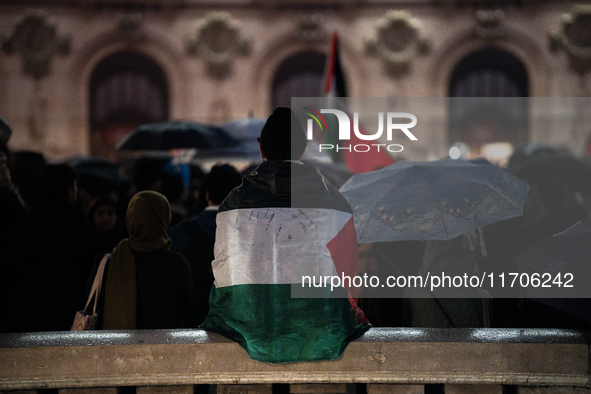 Protesters with flags attend a demonstration in support of Palestinian and Lebanese people as intense Israeli attacks occur in Gaza and Leba...