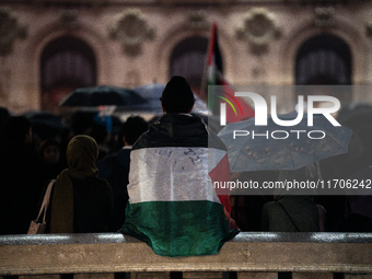 Protesters with flags attend a demonstration in support of Palestinian and Lebanese people as intense Israeli attacks occur in Gaza and Leba...