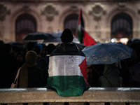 Protesters with flags attend a demonstration in support of Palestinian and Lebanese people as intense Israeli attacks occur in Gaza and Leba...