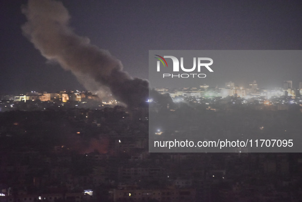 Smoke rises from the site of an Israeli airstrike that targets a neighborhood in Beirut's southern suburbs on October 25, 2024. Israel expan...