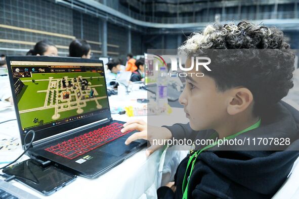 Participants program a robot during the Qingdao International Invitational Tournament of the 2024 Asia-Pacific RoboCup in Qingdao, China, on...