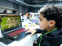 Participants program a robot during the Qingdao International Invitational Tournament of the 2024 Asia-Pacific RoboCup in Qingdao, China, on...