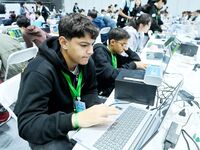 Participants program a robot during the Qingdao International Invitational Tournament of the 2024 Asia-Pacific RoboCup in Qingdao, China, on...