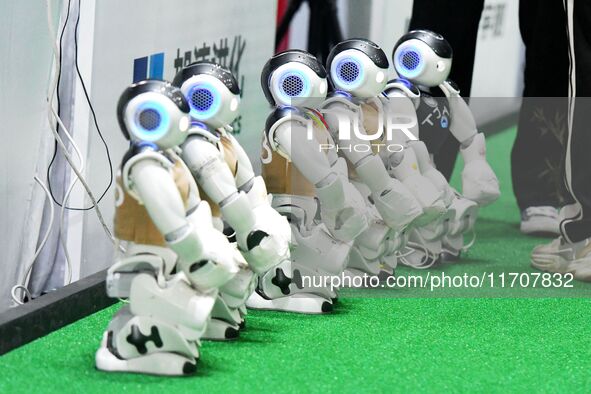 Robots charge during a break in the Qingdao International Invitational Tournament of the 2024 RoboCup Asia Pacific in Qingdao, China, on Oct...