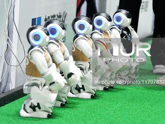 Robots charge during a break in the Qingdao International Invitational Tournament of the 2024 RoboCup Asia Pacific in Qingdao, China, on Oct...