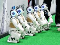 Robots charge during a break in the Qingdao International Invitational Tournament of the 2024 RoboCup Asia Pacific in Qingdao, China, on Oct...