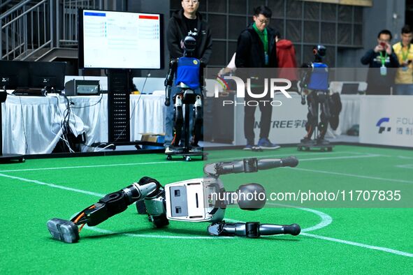 A robot performs lying down during the 2024 Asia Pacific Robot World Cup Qingdao International Invitational in Qingdao, Shandong, China, on...