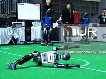 A robot performs lying down during the 2024 Asia Pacific Robot World Cup Qingdao International Invitational in Qingdao, Shandong, China, on...