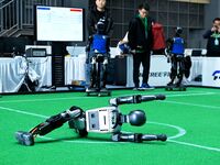 A robot performs lying down during the 2024 Asia Pacific Robot World Cup Qingdao International Invitational in Qingdao, Shandong, China, on...