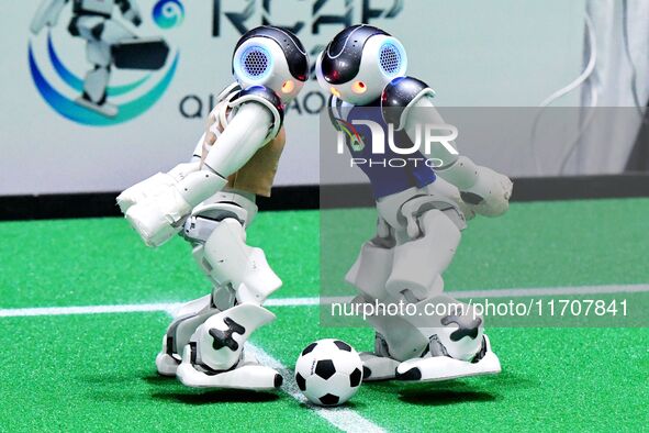 Robots play soccer at the 2024 Asia Pacific Robot World Cup Qingdao International Invitational in a football match in Qingdao, China, on Oct...